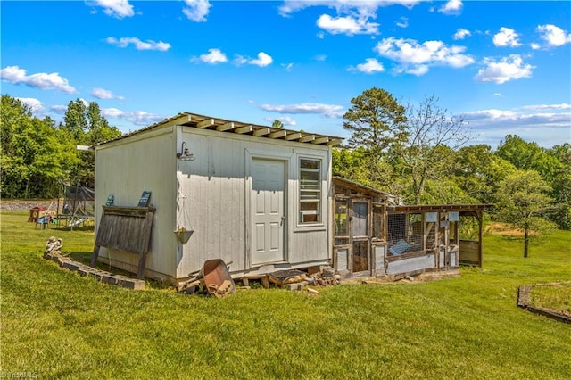 view of poultry coop featuring a lawn