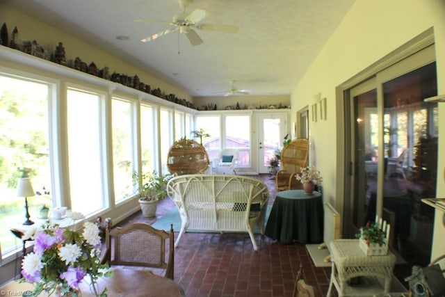 sunroom / solarium with a healthy amount of sunlight and ceiling fan