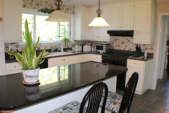 kitchen with white cabinetry, sink, and decorative light fixtures