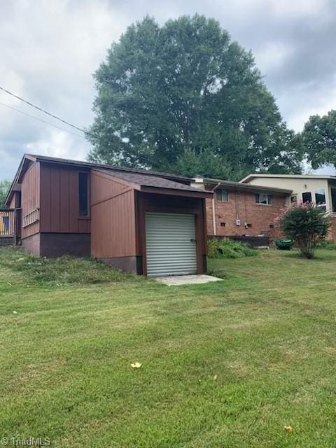 view of outbuilding with a yard