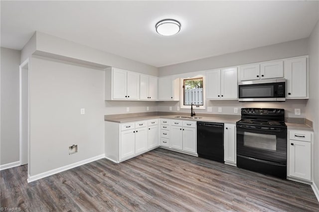 kitchen with a sink, wood finished floors, black appliances, and light countertops
