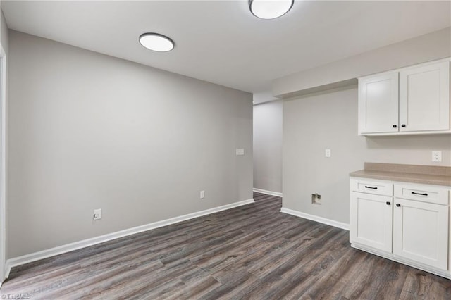 interior space featuring baseboards and dark wood finished floors
