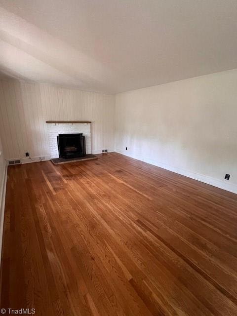 unfurnished living room with hardwood / wood-style floors and a fireplace