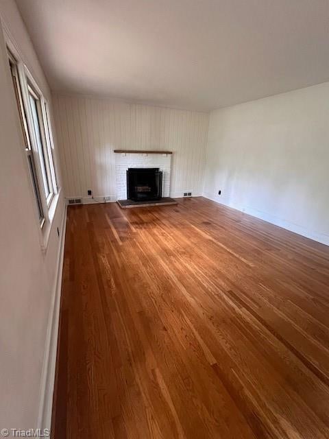 unfurnished living room with hardwood / wood-style floors and a fireplace