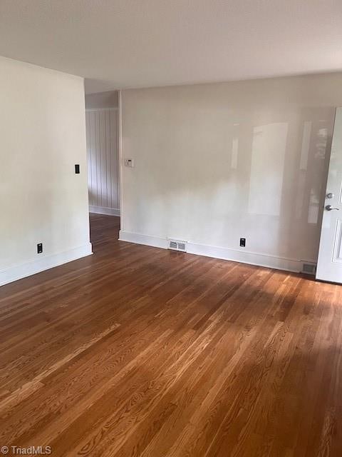 spare room featuring dark hardwood / wood-style flooring