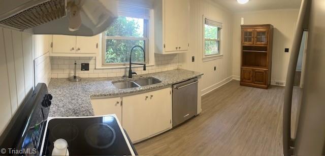 kitchen with plenty of natural light, tasteful backsplash, and stainless steel dishwasher