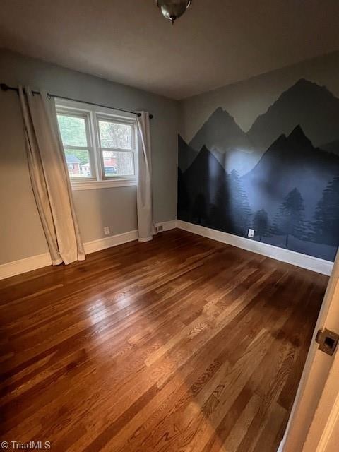 spare room with wood-type flooring