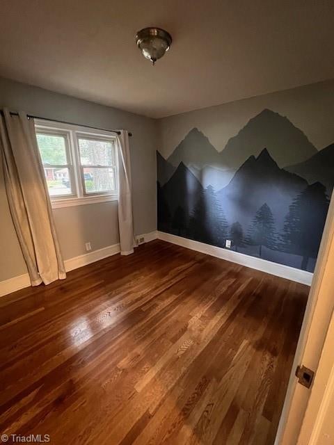 unfurnished room featuring hardwood / wood-style flooring