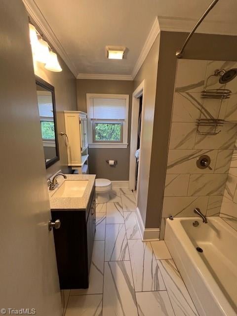 full bathroom with toilet, tiled shower / bath, vanity, and a wealth of natural light