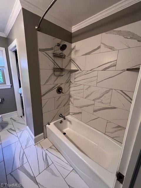 bathroom with tiled shower / bath and crown molding