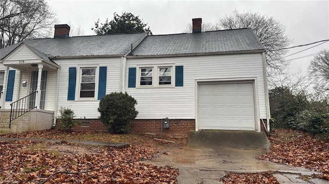 516 Hamilton St, Eden, NC 27288 - view of side of home featuring a chimney, a garage, driveway, and crawl space