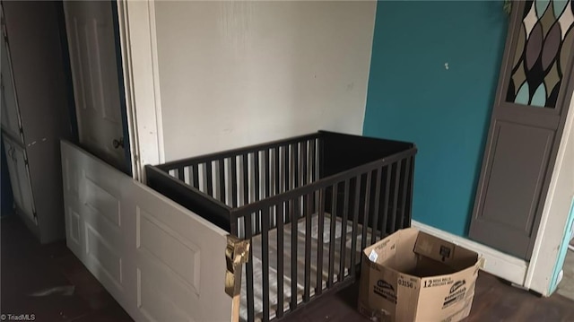 516 Hamilton St, Eden, NC 27288 - bedroom featuring a crib and dark wood-style floors
