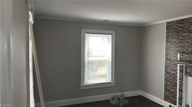 516 Hamilton St, Eden, NC 27288 - unfurnished room featuring a textured ceiling, ornamental molding, baseboards, and dark wood-style floors
