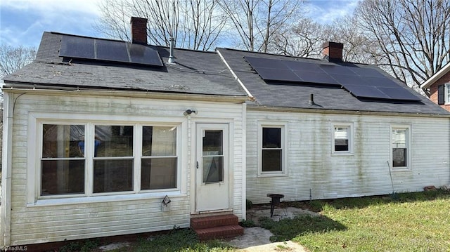 516 Hamilton St, Eden, NC 27288 - rear view of property featuring entry steps, a chimney, and solar panels