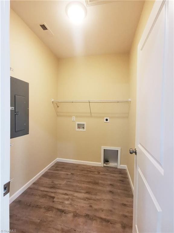 washroom featuring electric panel, electric dryer hookup, washer hookup, and dark hardwood / wood-style flooring