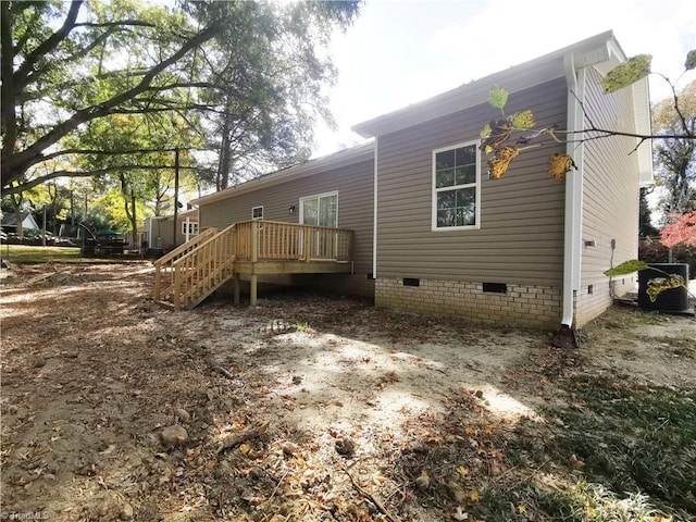 back of house featuring a deck