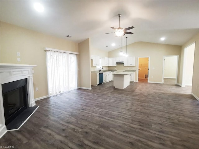 unfurnished living room with lofted ceiling, sink, dark wood-type flooring, and ceiling fan