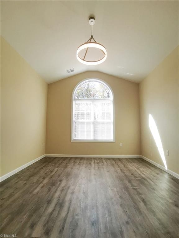 unfurnished room with vaulted ceiling and dark hardwood / wood-style floors