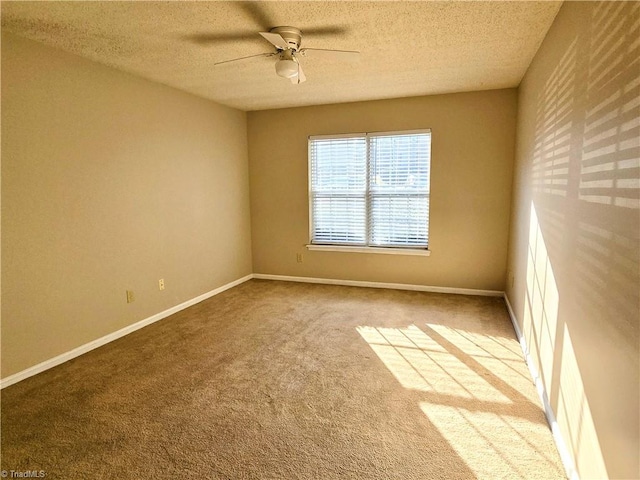 spare room featuring a textured ceiling, ceiling fan, and carpet flooring