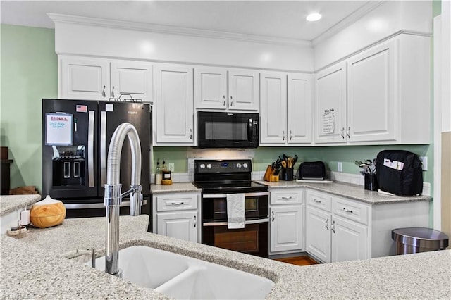 kitchen with white cabinetry, black appliances, light stone counters, and ornamental molding