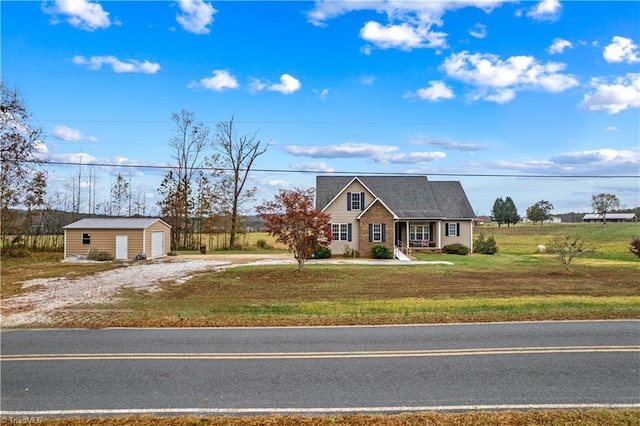 view of front of property featuring an outbuilding and a front lawn