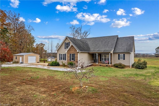 view of front of property with a garage, an outdoor structure, a front yard, and a porch