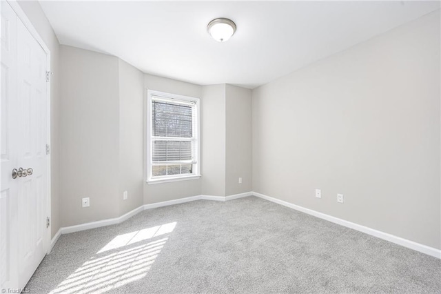 empty room featuring light colored carpet