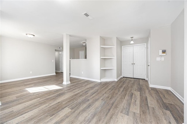 interior space featuring built in features and hardwood / wood-style flooring