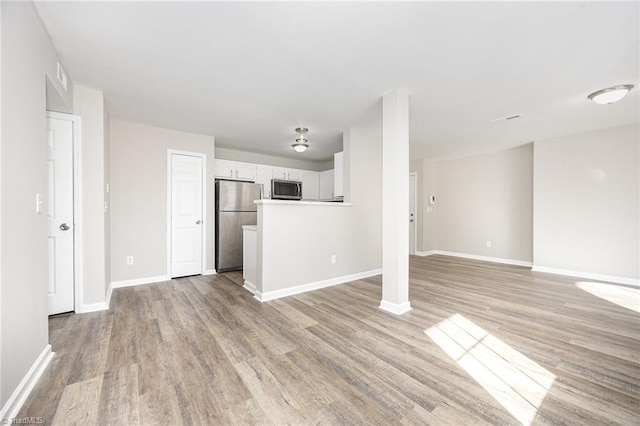 unfurnished living room with light hardwood / wood-style flooring