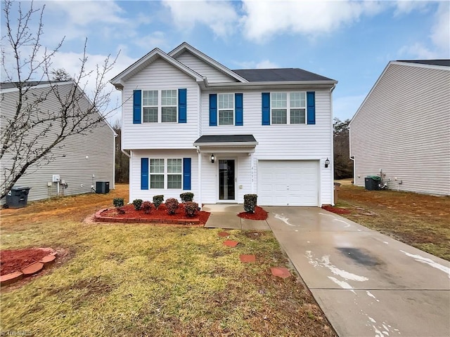 view of front of house featuring cooling unit, driveway, a front yard, and an attached garage