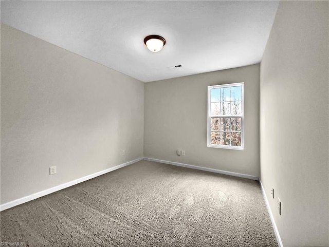 carpeted empty room featuring visible vents and baseboards