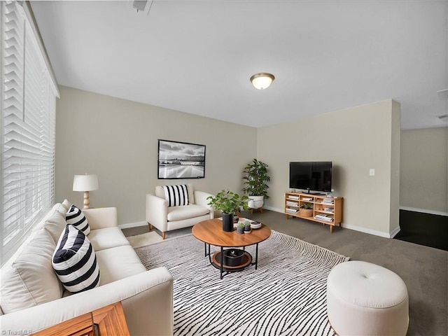 living area featuring baseboards