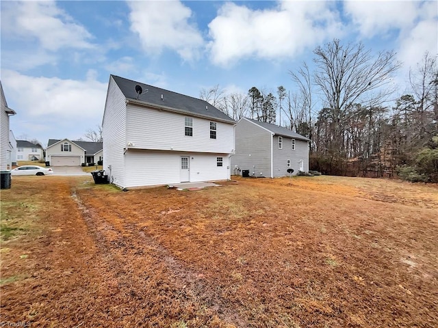 back of property with a lawn, a patio, and central AC