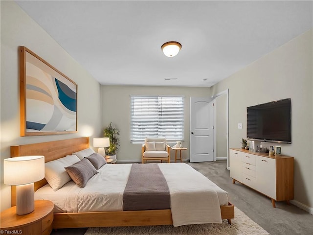 bedroom with visible vents, baseboards, and light carpet