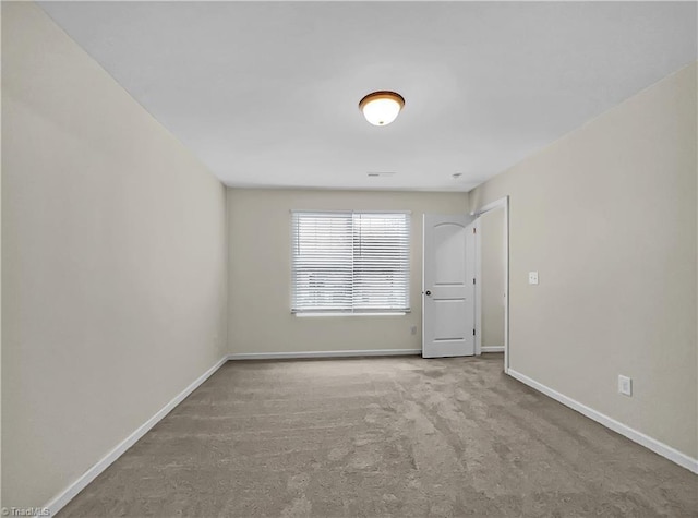 empty room with baseboards and carpet floors