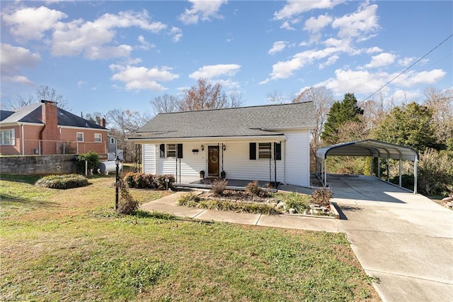 view of front of property with a front lawn, covered porch, and a carport