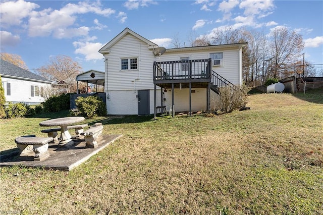 rear view of house featuring a deck and a yard