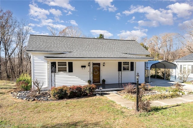 view of front of house with covered porch, a front yard, and a carport