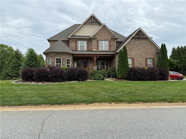 craftsman-style home with brick siding and a front lawn