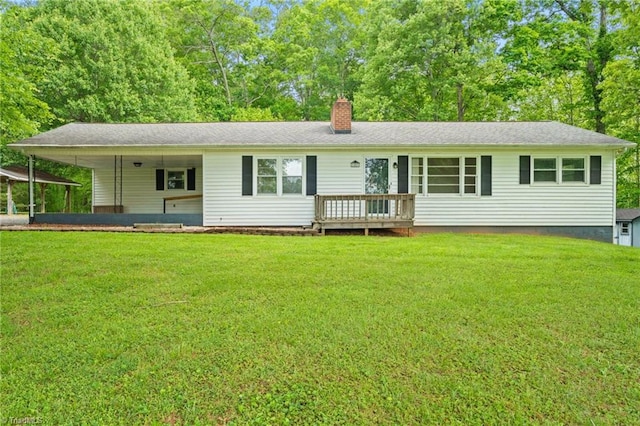 1553 Carson Rd, Pilot Mountain, NC 27041 - rear view of house featuring a chimney, a lawn, a carport, and a deck