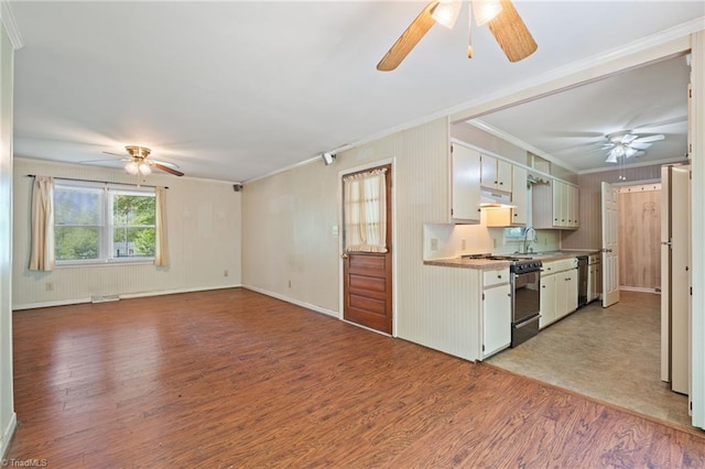1553 Carson Rd, Pilot Mountain, NC 27041 - kitchen with a ceiling fan, gas range oven, crown molding, dishwasher, and light wood-style floors