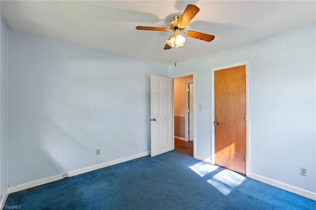1553 Carson Rd, Pilot Mountain, NC 27041 - unfurnished bedroom with carpet floors, baseboards, and a ceiling fan