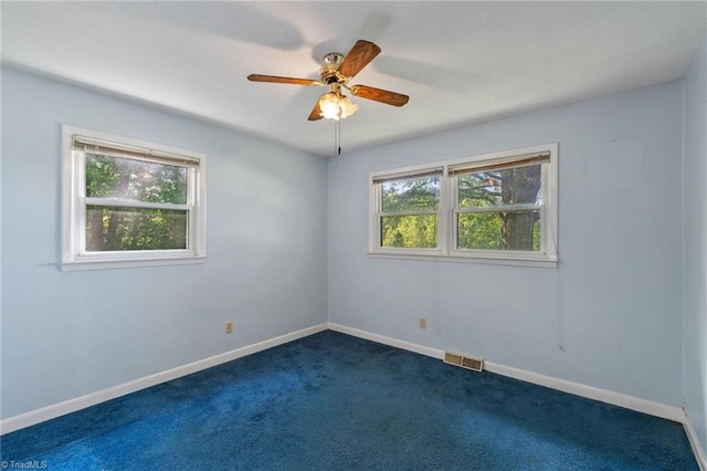 1553 Carson Rd, Pilot Mountain, NC 27041 - empty room with a ceiling fan, dark carpet, and baseboards
