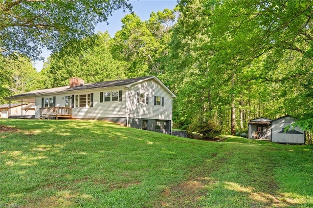 1553 Carson Rd, Pilot Mountain, NC 27041 - back of property featuring a deck, a storage shed, a lawn, and a chimney