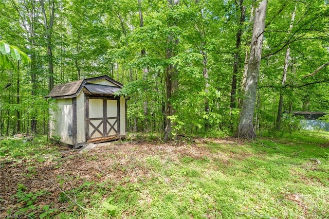 1553 Carson Rd, Pilot Mountain, NC 27041 - view of yard featuring a shed, an outbuilding, and a forest view