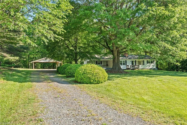 1553 Carson Rd, Pilot Mountain, NC 27041 - view of front of house with gravel driveway, a front lawn, and a carport