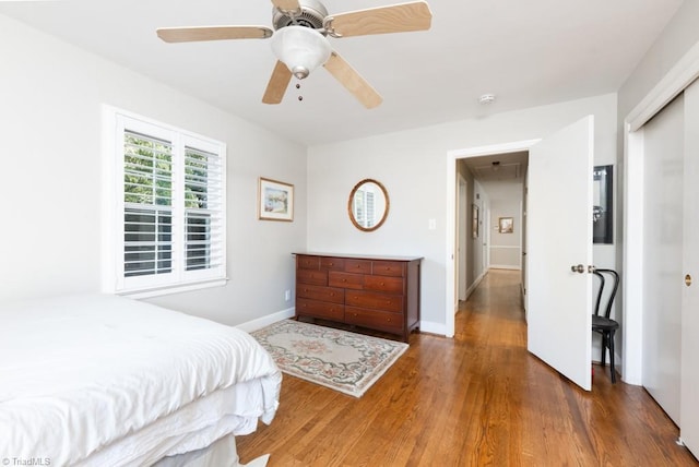 bedroom with ceiling fan and dark hardwood / wood-style flooring