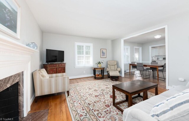 dining area featuring a wealth of natural light, sink, and light hardwood / wood-style floors