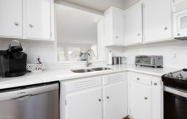 kitchen with appliances with stainless steel finishes, white cabinetry, and sink