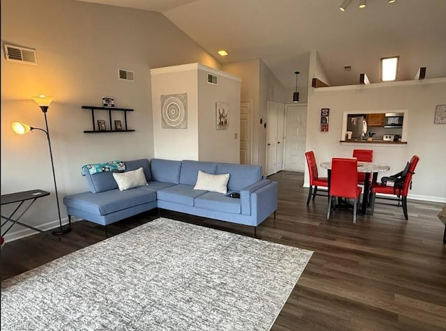 living room with high vaulted ceiling, wood finished floors, visible vents, and baseboards